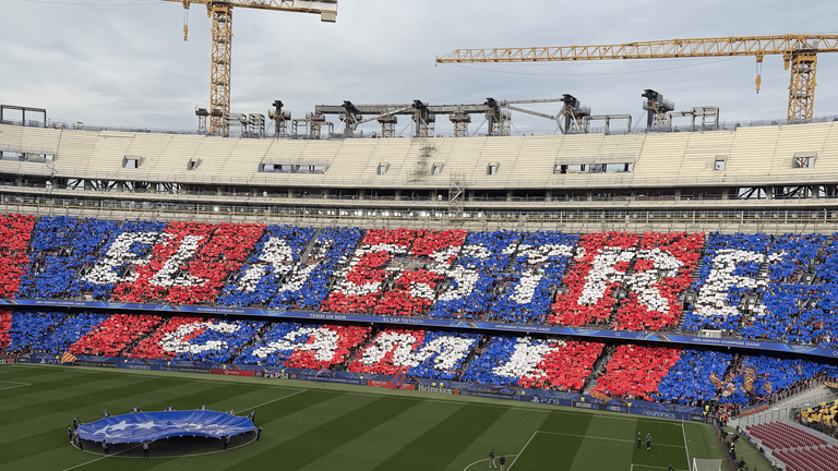 Barcelona fans welcome the two sides to the pitch ahead of a third Clasico meeting in eight days