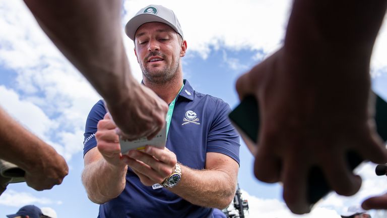 Bryson DeChambeau signs autographs at Augusta National ahead of the 2026 Masters
