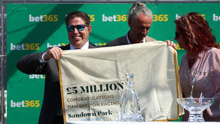 Trainer Dan Skelton celebrates after becoming the first trainer to surpass 5 million in prize money in a season at Sandown Park