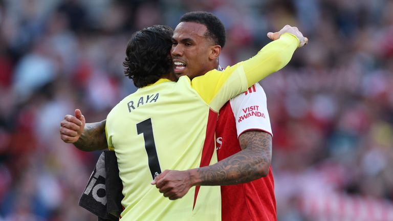 Arsenal goalkeeper David Raya embraces team-mate Gabriel at full time after the win over Newcastle