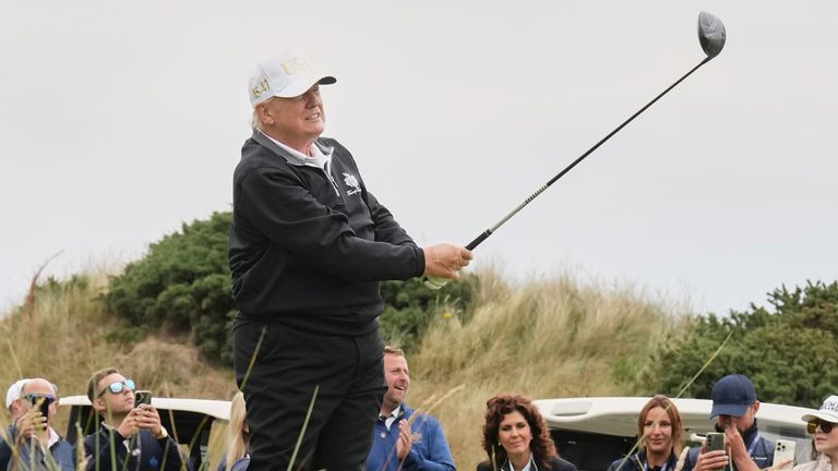 Donald Trump hits a tee shot while playing in Scotland