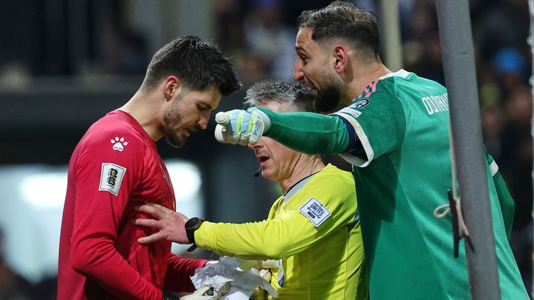 Bosnian goalkeeper Nikola Vasilj, left, and Italy goalkeeper Gianluigi Donnarumma argue during a penalty shootout during the World Cup qualifying playoff final soccer match between Bosnia and Italy in Zenica, Bosnia, Tuesday, March 31, 2026. (AP Photo/Armin Durgut)