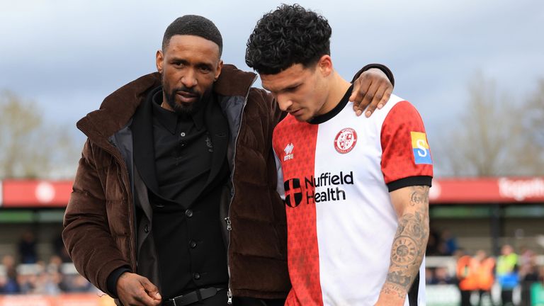 Jermain Defoe and Woking right-back Aaron Drew