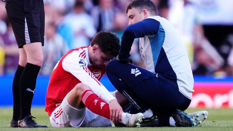 Arsenal's Kai Havertz receives treatment from medical staff after going down injured