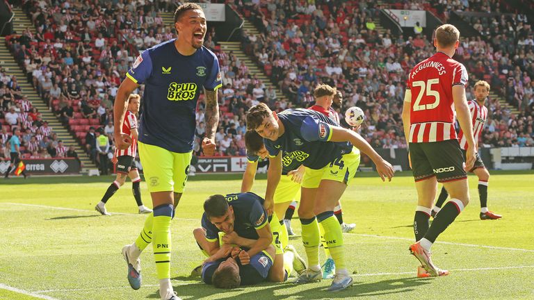 Preston's Liam Lindsay (grounded) is mobbed by team-mates after scoring his side's second goal