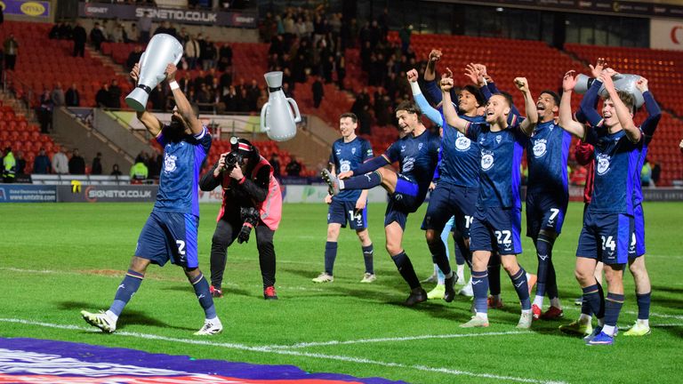 Lincoln City celebrate after winning the League One title