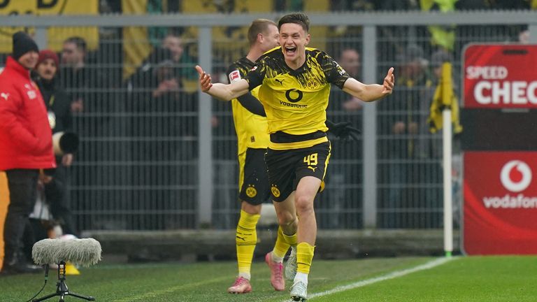  Luca Reggiani celebrates scoring his team's second goal during the Bundesliga match against Augsburg