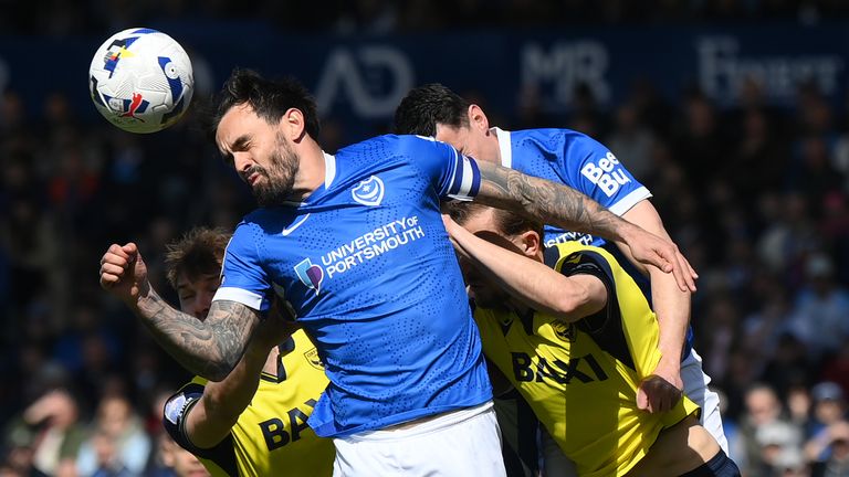 Marlon Pack of Portsmouth wins a header against Michal Helik of Oxford United