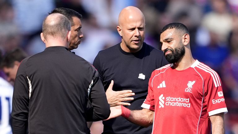 Mohamed Salah speaks with Arne Slot after being substituted 
