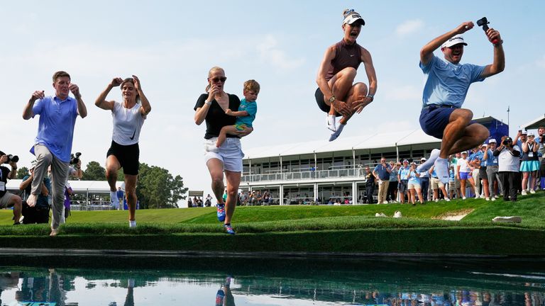 Nelly Korda celebrates by jumping in the water after winning the Chevron Championship