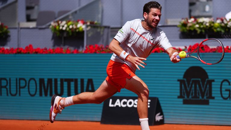 Cameron Norrie of Britain returns the ball to Jannik Sinner of Italy during their round of 16 match at the Madrid Open tennis tournament in Madrid, Tuesday, April 28, 2026. (AP Photo/Manu Fernandez)
