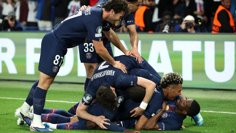 PSG players smother Ousmane Dembele as they celebrate his second goal in their thrilling 5-4 win over Bayern Munich