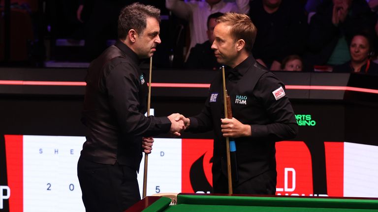 Ronnie O'Sullivan of England shakes hands with Ali Carter of England following the first round match on day five of the Halo World Snooker C