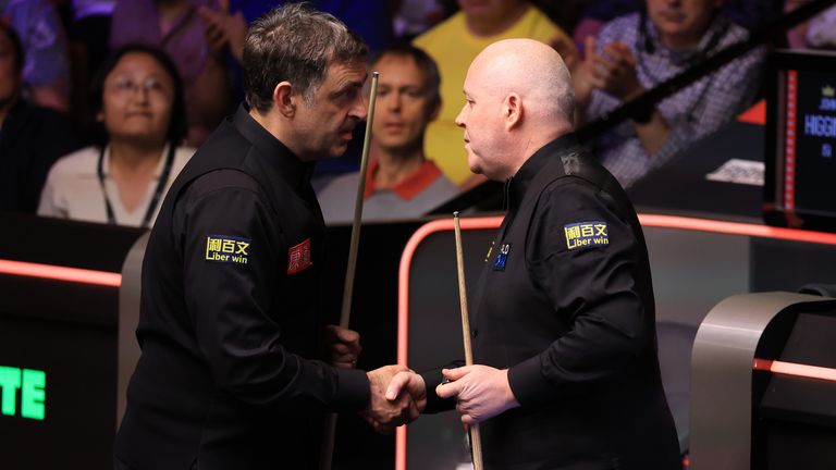 Ronnie O'Sullivan and John Higgins shake hands after their match on day ten of the Halo World Snooker Championship 2026 at the Crucible Thea