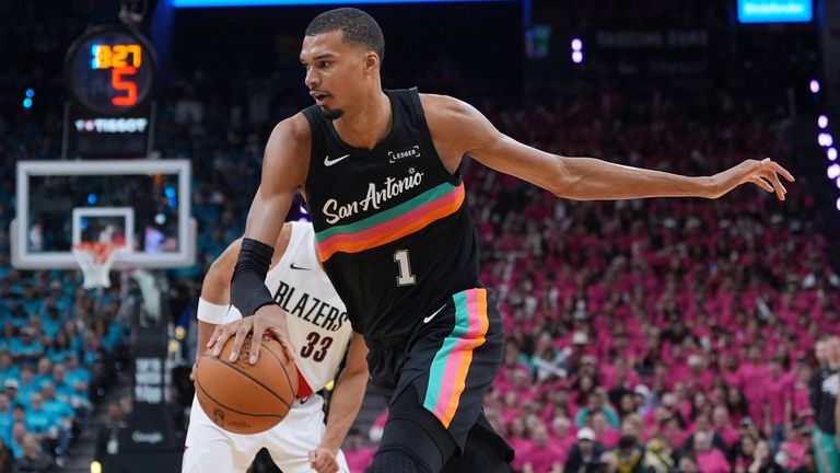 San Antonio Spurs forward Victor Wembanyama (1) drives past Portland Trail Blazers forward Toumani Camara (33) during the second half in Game 1 of a first-round NBA playoffs basketball series in San Antonio, Sunday, April 19, 2026. (AP Photo/Eric Gay)