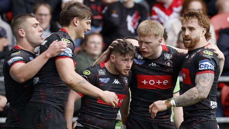 Wigan Warriors' Jack Farrimond (centre) celebrates with his team-mates after scoring a try against St Helens 