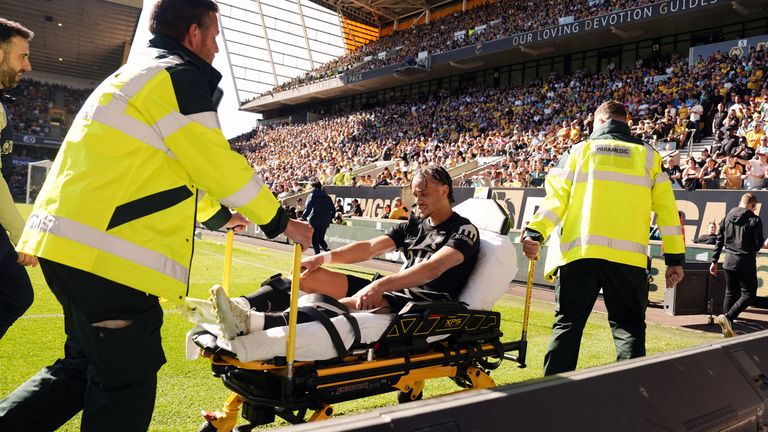 Xavi Simons leaves on a stretcher after suffering an injury for Spurs in their win at Wolves