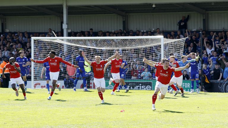 York City's players celebrate after Josh Stones scores a late equaliser against Rochdale