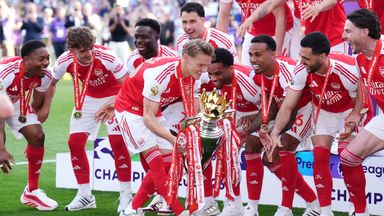 Arsenal's Martin Odegaard lifts the Premier League trophy