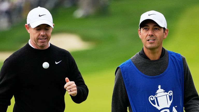 Rory McIlroy, of Northern Ireland, walks with his caddie to the 11th hole during the first round of the PGA Championship