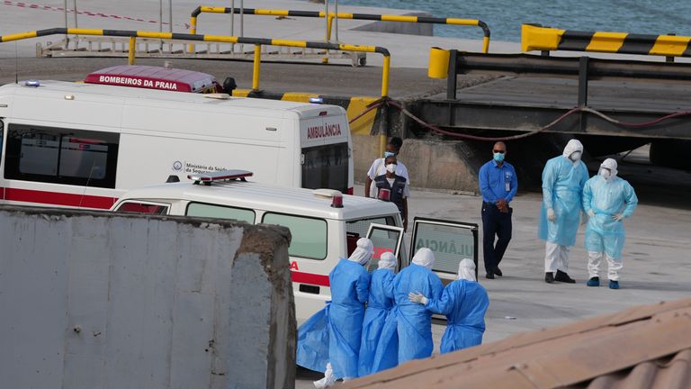 Health workers in protective gear evacuate patients from the MV Hondius cruise ship at a port in Praia, Cape Verde, Wednesday, May 6, 2026. (AP Photo/Misper Apawu)