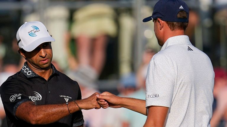 Aaron Rai, of England, celebrates with Ludvig ..berg, of Sweden, after his shot on the 17th green  at the PGA Championship