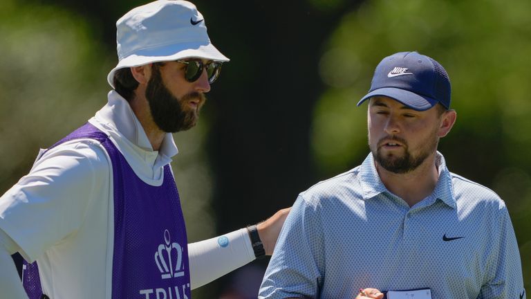 Alex Fitzpatrick, of England, reacts with his caddie after a birdie on the fifth hole during the final round of the Truist Championship