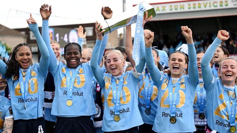Alex Greenwood lifts the WSL trophy and celebrates with her Manchester City team-mates