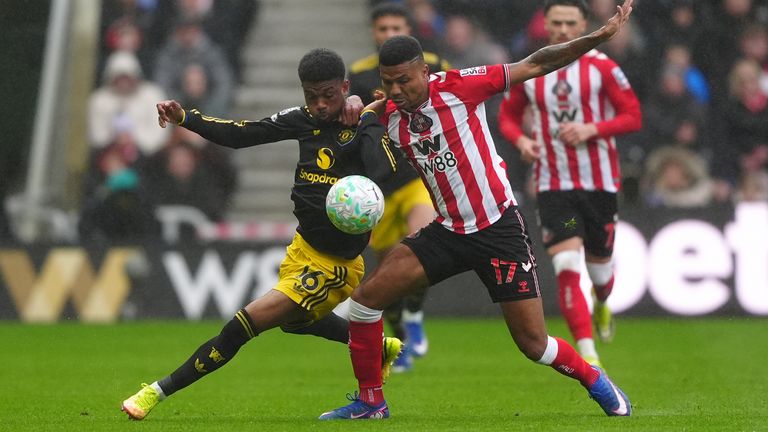 Manchester United's Amad Diallo (left) and Sunderland's Reinildo Mandava compete for possession