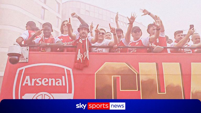 Arsenal players celebrate on the bus