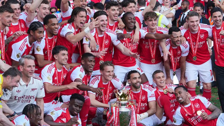 Arsenal players celebrate with Premier League the trophy (AP Photo/Kin Cheung)