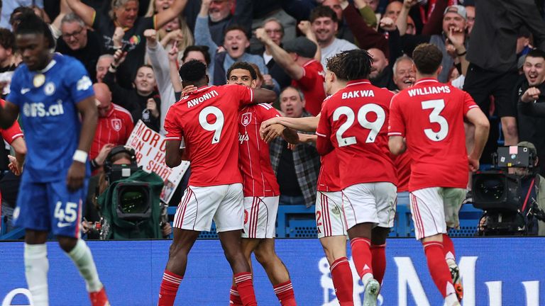Nottingham Forest's Nigerian striker #09 Taiwo Awoniyi (L) celebrates with teammates after scoring his team's third goal during the English Premier League football match between Chelsea and Nottingham Forest at Stamford Bridge in London on May 4, 202