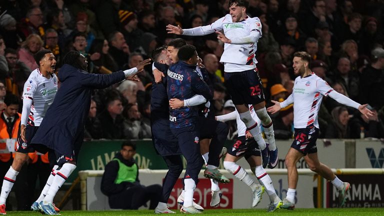 Bolton players celebrate Xavier Simons' late goal that sealed a 2-0 aggregate win over Bradford