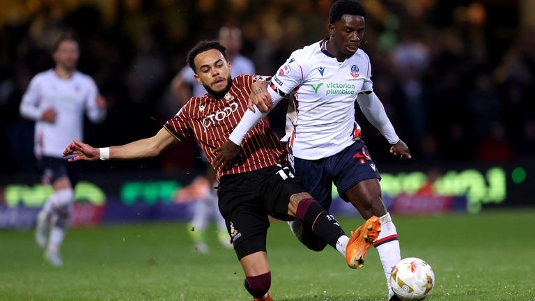 Bolton's Jordi Osei-Tutu is challenged by Bradford's Tyreik Wright during the League One play-off semi-final second leg