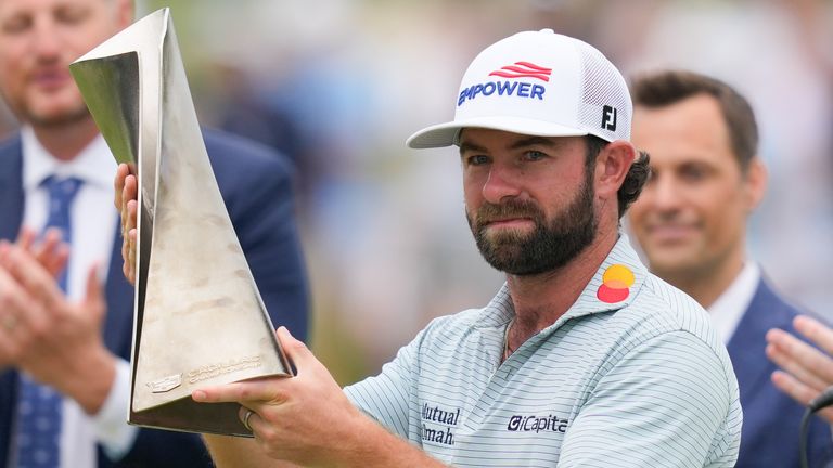 Cameron Young poses with the trophy after winning the Cadillac Championship