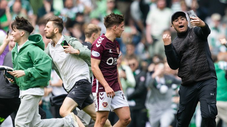 GLASGOW, SCOTLAND - MAY 16: Hearts' Cammy Devlin (L) and a Celtic fan during a William Hill Premiership match between Celtic and Heart of Midlothian at Celtic Park, on May 16, 2026, in Glasgow, Scotland. (Photo by Craig Foy / SNS Group)
