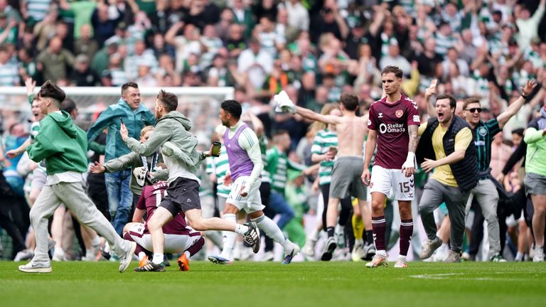 Celtic fans invaded the pitch after Callum Osmand's goal secured the title