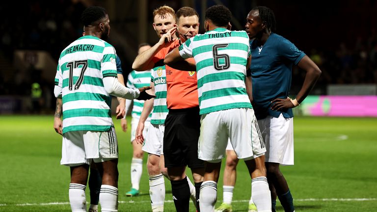 Referee John Beaton speaks to Celtic's Auston Trusty before going to the VAR monitor and awarding a penalty