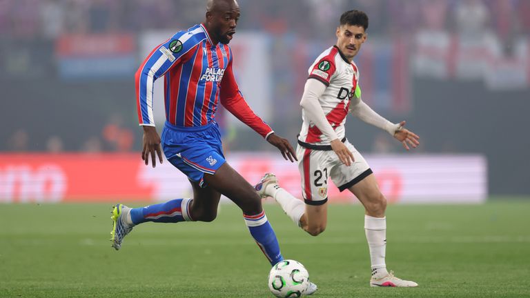 Crystal Palace's Jean-Philippe Mateta tries to stride away from Rayo Vallecano's Oscar Valentin