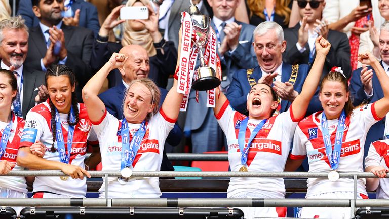 Jodie Cunningham and Emily Roose of StHlens lift the Challenge Cup trophy