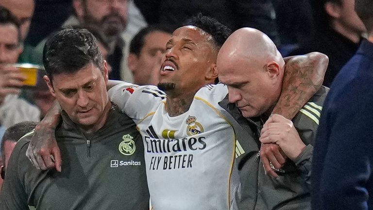 Real Madrid's Eder Militao is assisted from the pitch after getting an injury