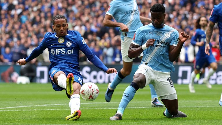 Joao Pedro slips as he attempts a shot at the Man City goal