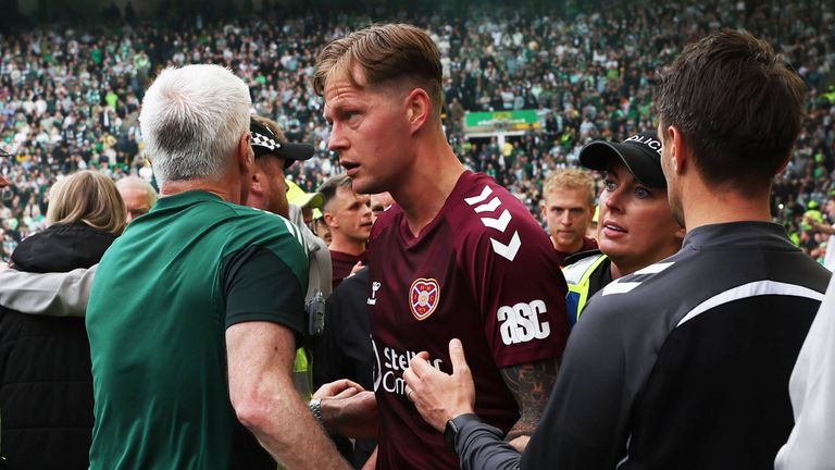 GLASGOW, SCOTLAND - MAY 16: Hearts Frankie Kent is ushered off the pitch after Celtic score to make it 3-1 during a William Hill Premiership match between Celtic and Heart of Midlothian at Celtic Park, on May 16, 2026, in Glasgow, Scotland. (Photo by Craig Foy / SNS Group)