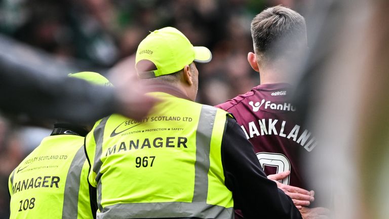Hearts' Lawrence Shankland with stewards at full-time at Celtic Park