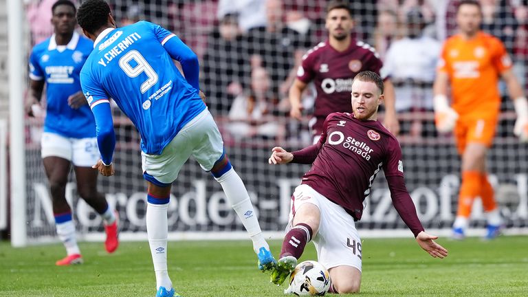 Heart of Midlothian's Marc Leonard (right) tackles Rangers' Youssef Chermiti