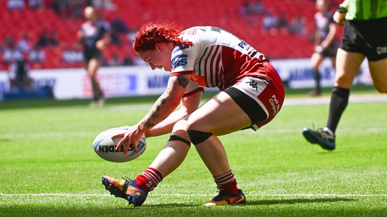 Wigan's Eva Hunter is scores a try against St Helens.