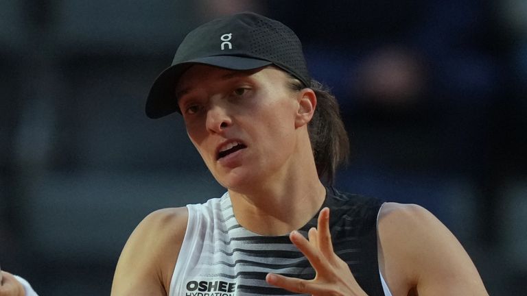 Iga Swiatek returns a shot at the net during the Italian Open