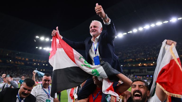 Manager Graham Arnold is held aloft after guiding Iraq to the World Cup