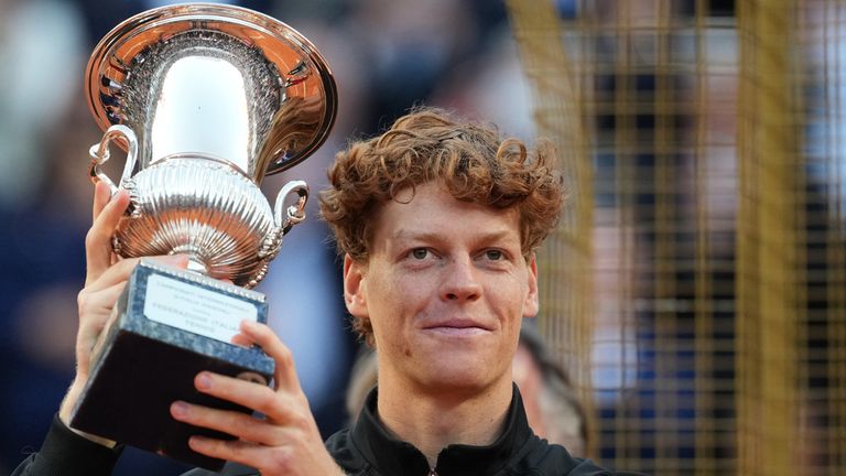 Jannik Sinner, of Italy, holds his trophy after defeating Casper Ruud, of Norway, 6/4, 6/4 in the final match to win the Italian Open tennis