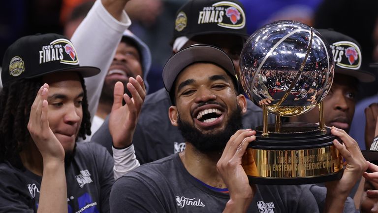 New York Knicks center Karl-Anthony Towns, center, and teammates celebrate after winning Game 4 in the Eastern Conference finals